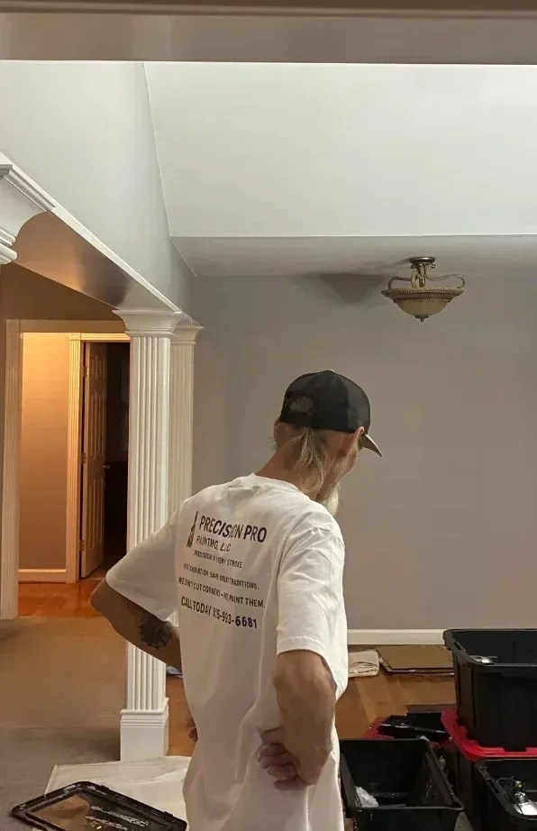 A member of the Precision Pro Painting team working carefully on a residential interior